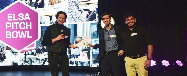 Three people on stage at ELSA Pitch Bowl 2023 - winner fluorizon receives award certificate worth €200.